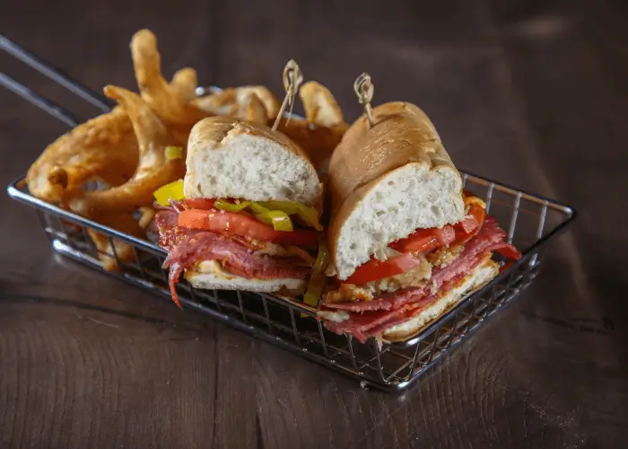 sandwich with fries in a metal basket