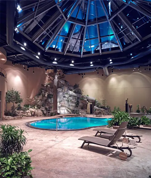 An image of the pool area highlighting the lounges and the waterfall.