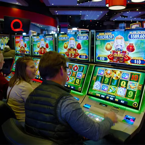 An image of people playing on slot machines.